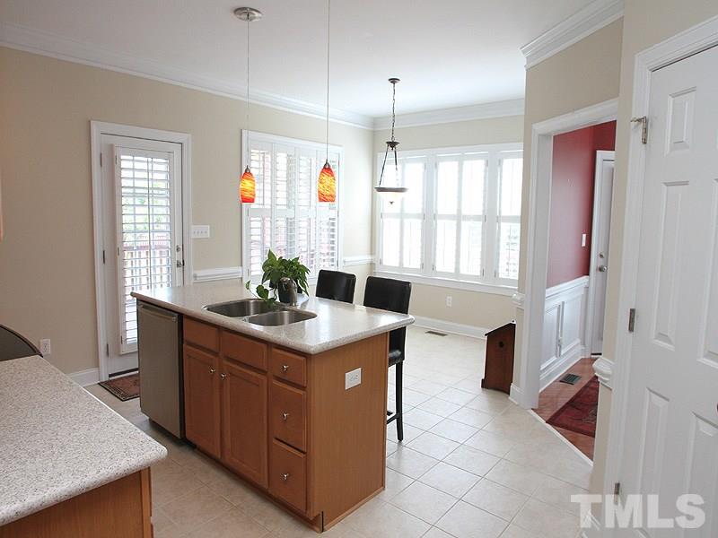 1036 Newburgh Circle Raleigh, NC 27603 - Photo 8 of 25 a kitchen with a sink stove and cabinets