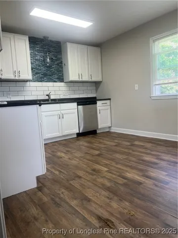 a kitchen with granite countertop a stove a sink and a granite counter tops