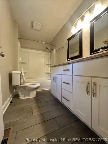 a bathroom with a sink a toilet and mirror