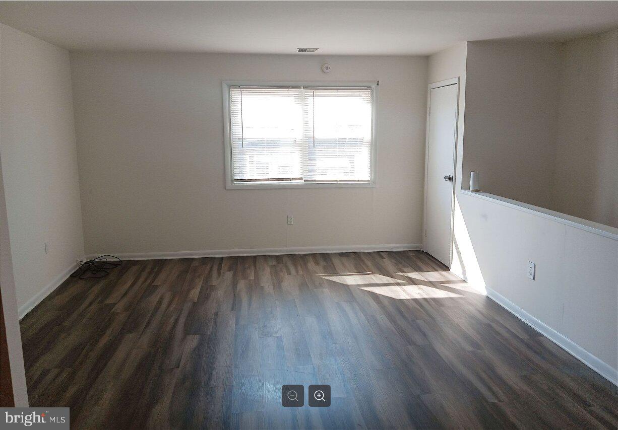 5304 Jackson Street, Unit 2 Philadelphia, PA 19124 - Photo 3 of 6 an empty room with wooden floor and windows