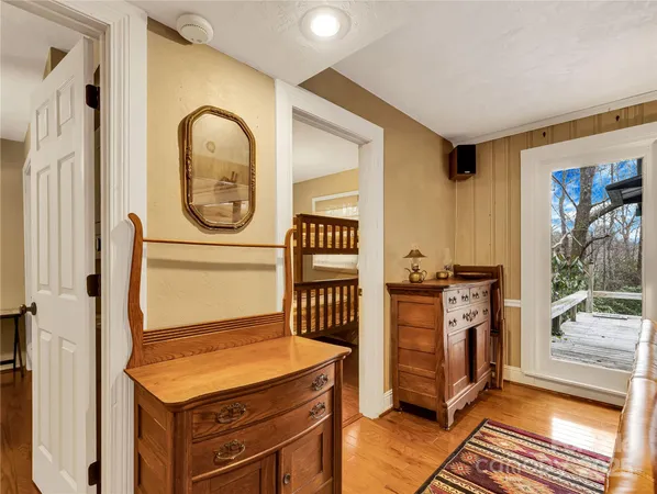 a room with furniture a mirror and a window