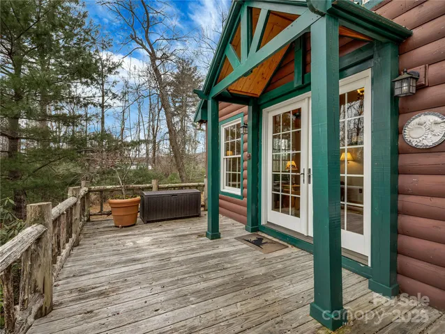 a view of a patio with couches and table and chairs and wooden floor
