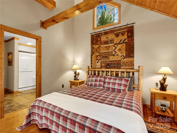 a bedroom with a bed and wooden floor