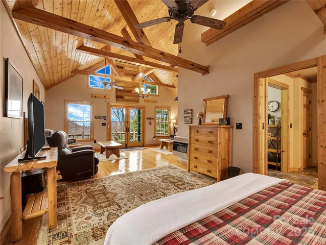 a bedroom with furniture and a flat screen tv