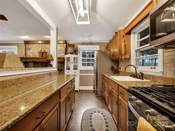 a kitchen with stainless steel appliances granite countertop a stove and a sink