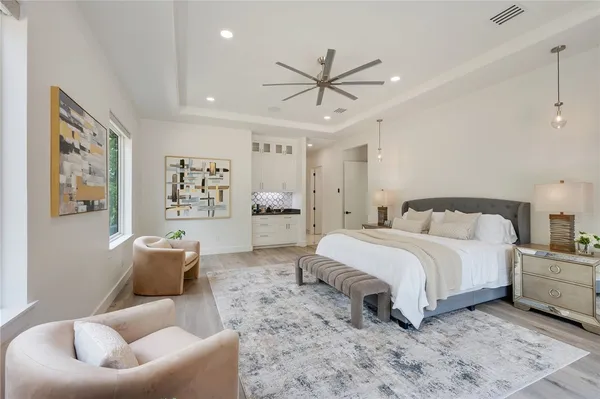 a spacious bedroom with a bed and a couch