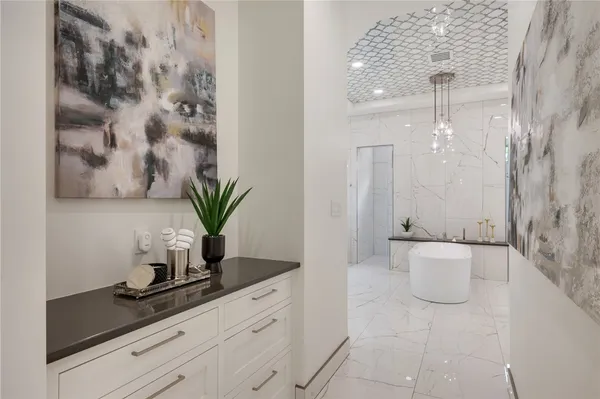 a bathroom with a granite countertop sink a toilet and bathtub