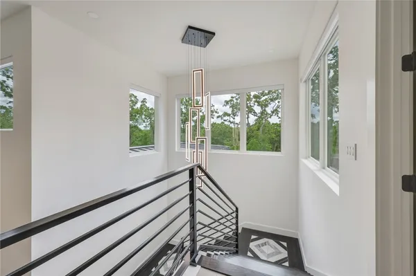 a view of a room that has a window and wooden floor