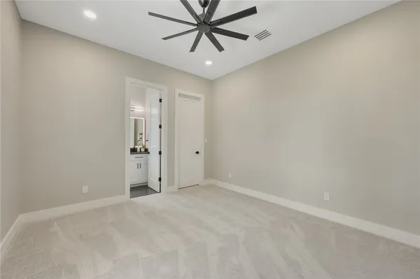 an empty room with chandelier fan