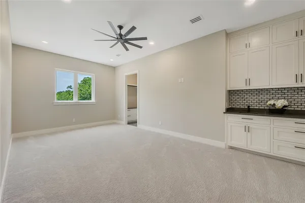 a view of an empty room with window and cabinet