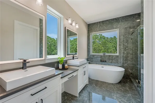 a bathroom with a double vanity sink and a bathtub