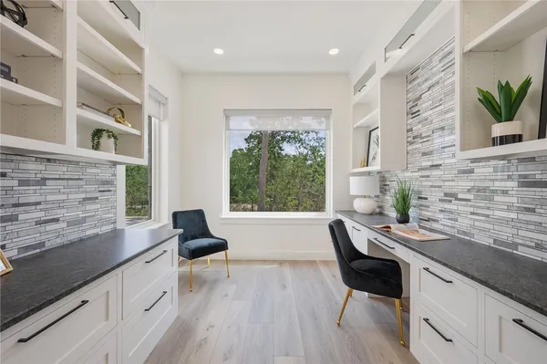 a kitchen with a table chairs stove and cabinets
