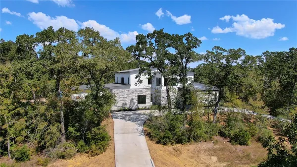 a view of a house with a tree in the background