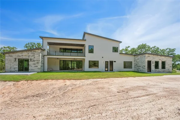 an aerial view of a house with yard and outdoor seating