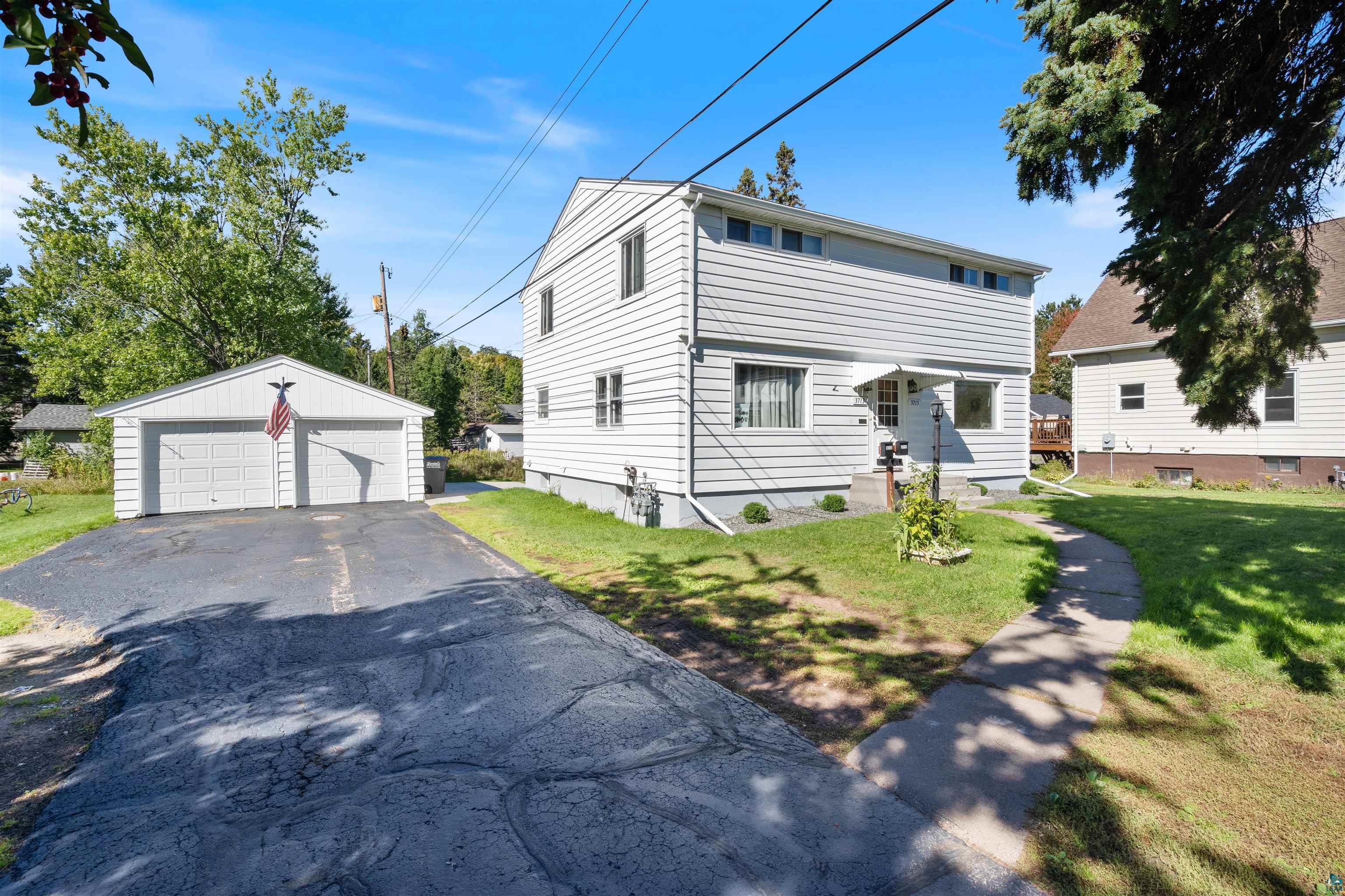 3715 Rendle Avenue Duluth, MN 55803 - Photo 5 of 20 Two-story residence with horizontal siding, a covered entry, and multiple windows