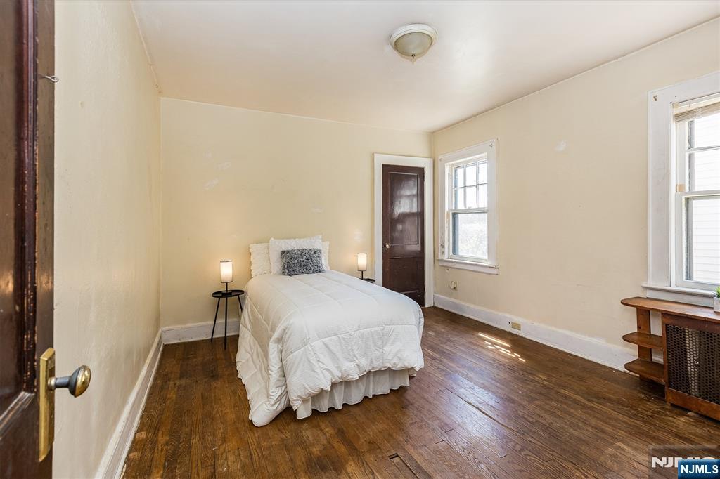 734 Broad Street Bloomfield, NJ 07003 - Photo 12 of 23 a bedroom with a bed and wooden floor