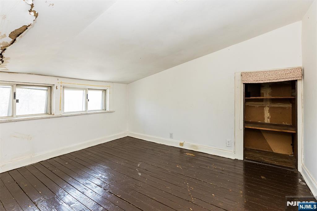 734 Broad Street Bloomfield, NJ 07003 - Photo 18 of 23 a view of empty room with wooden floor and fan