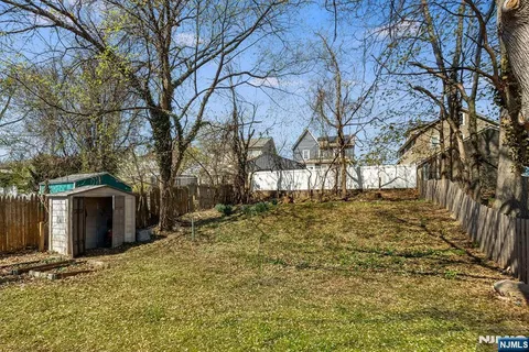 a large tree in front of a house