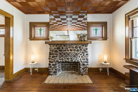 a living room with a fireplace and a window