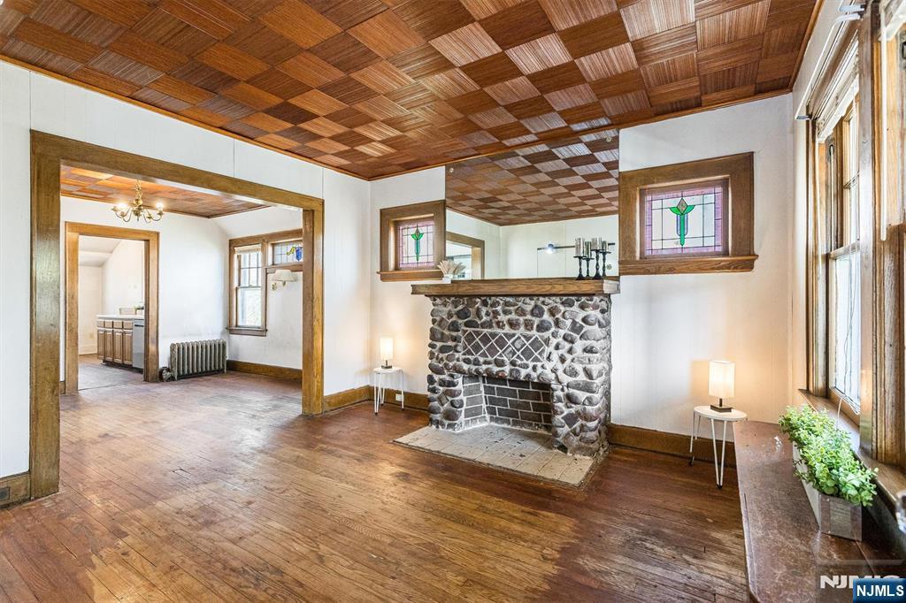 734 Broad Street Bloomfield, NJ 07003 - Photo 5 of 23 a view of an empty room with a fireplace and a window