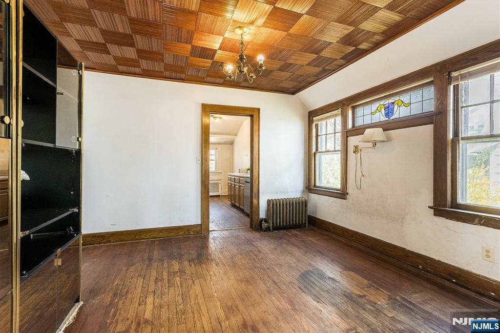734 Broad Street Bloomfield, NJ 07003 - Photo 7 of 23 a view of an empty room with wooden floor and a window