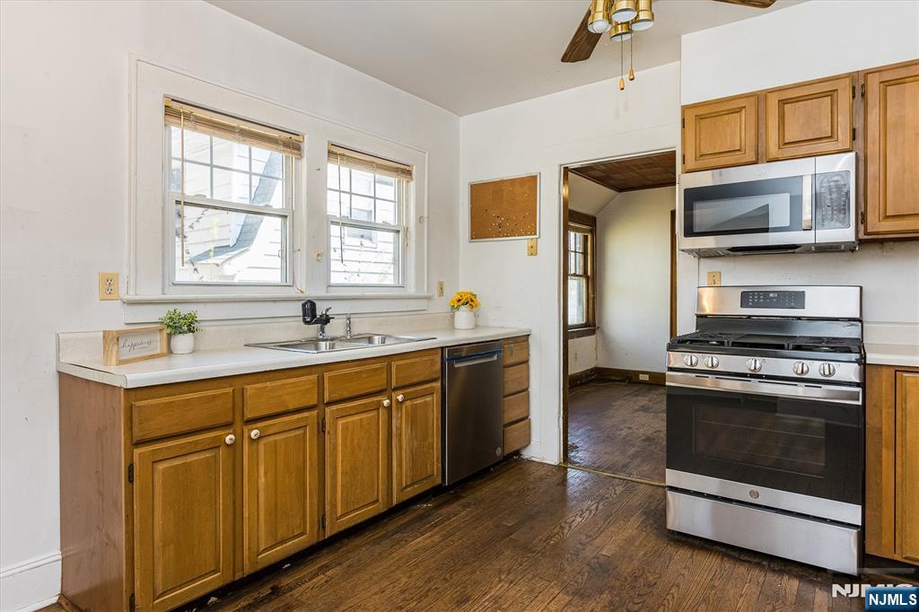 734 Broad Street Bloomfield, NJ 07003 - Photo 10 of 23 a kitchen with stainless steel appliances granite countertop a stove a sink and a microwave