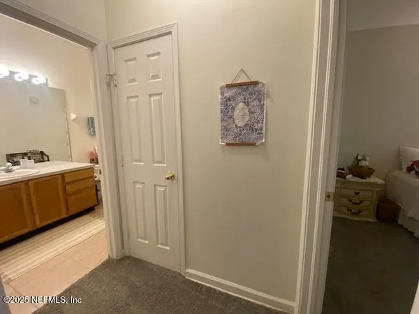 a bed sitting in a bedroom next to a book shelf