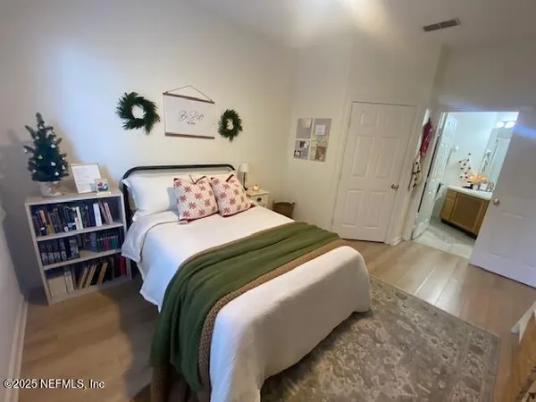 a bedroom with a bed and a book shelf