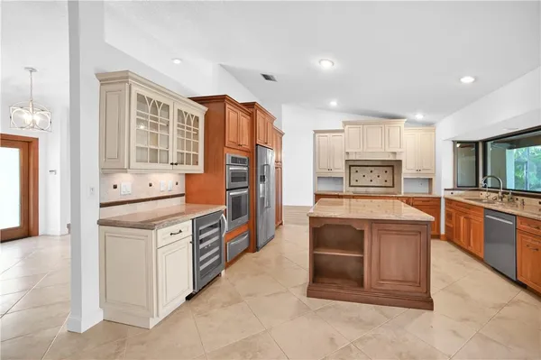 a kitchen with stainless steel appliances granite countertop a stove and more cabinets