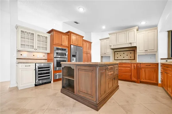 a kitchen with stainless steel appliances a refrigerator and stove