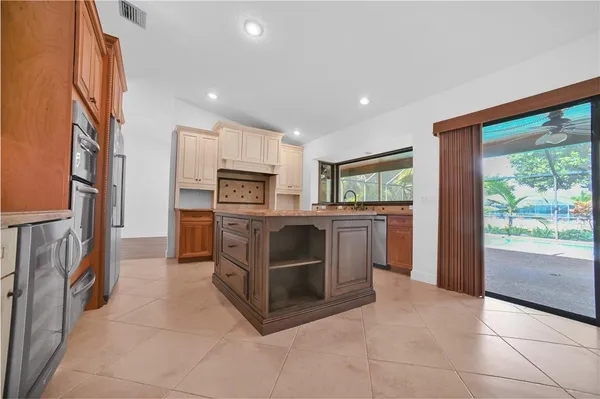 a kitchen with stainless steel appliances a stove a refrigerator and a sink