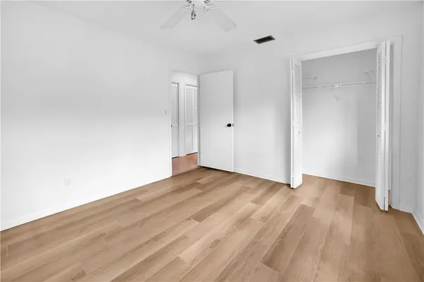a view of an empty room and wooden floor