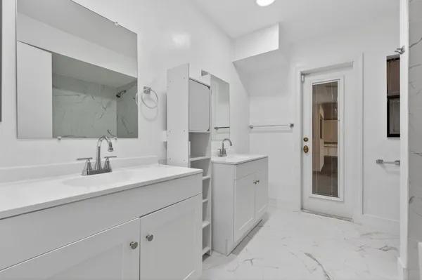 a spacious bathroom with a sink and a mirror