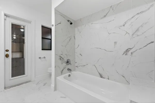 a bathroom with a bathtub and a shower