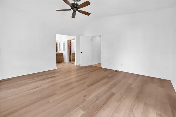 a view of a room with wooden floor and white walls