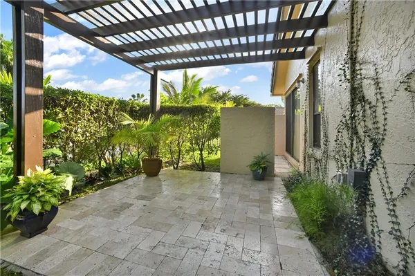 a view of a porch with potted plants