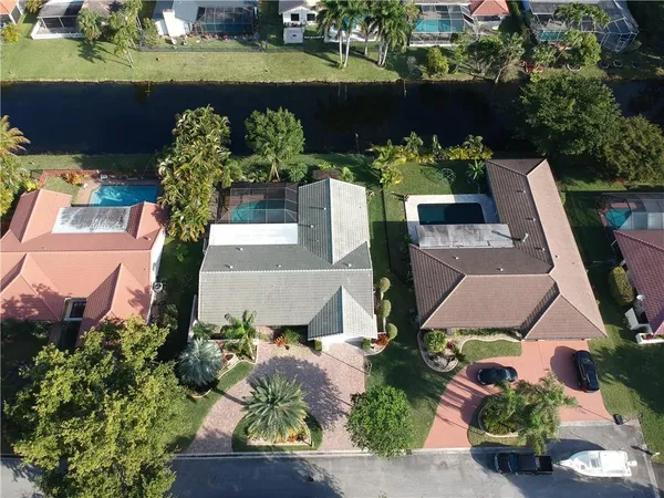 an aerial view of a house with a yard and pool