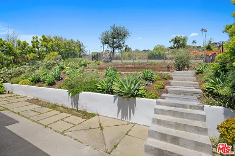 a view of a house with a yard and a fountain