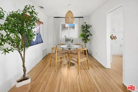 a dining room with furniture and wooden floor