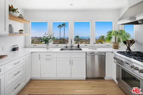 a kitchen with a sink stove and cabinets