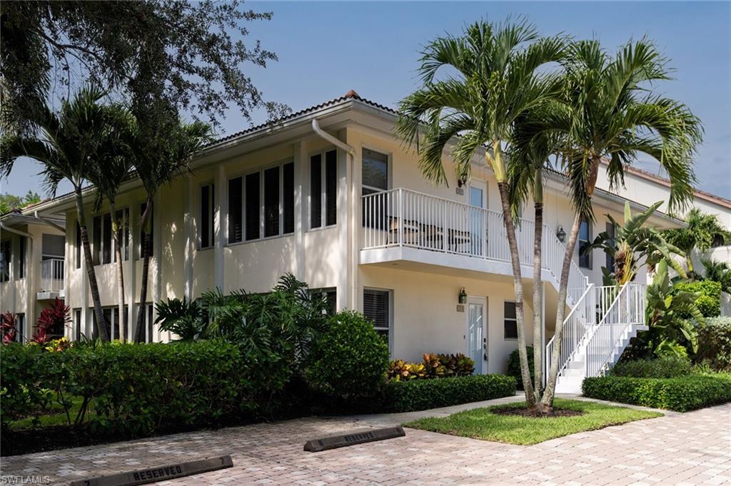 282 4th Street South, Unit 204 Naples, FL 34102 - Photo 11 of 16 a front view of a house with a garden