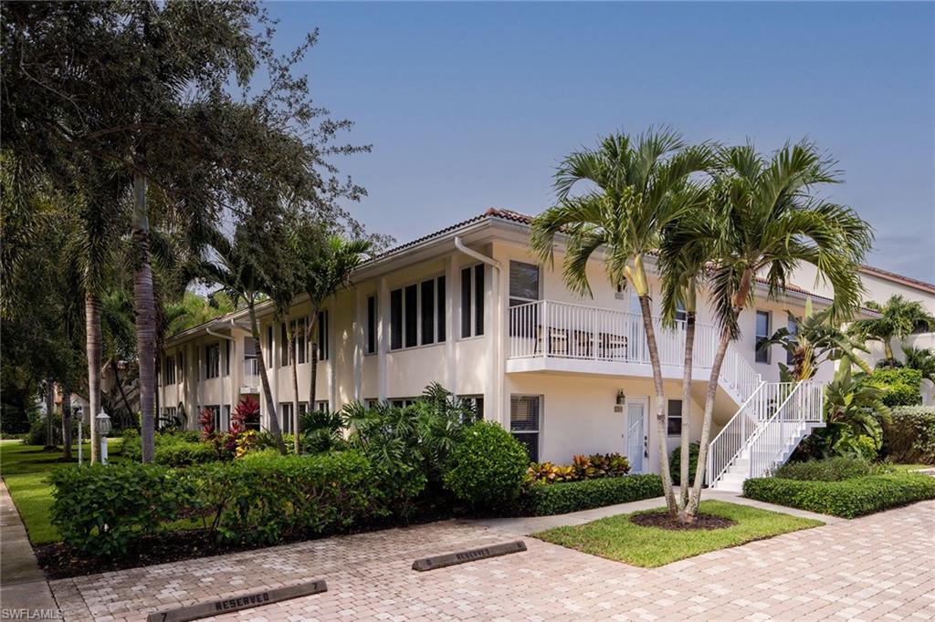 282 4th Street South, Unit 204 Naples, FL 34102 - Photo 12 of 16 a front view of a house with a garden