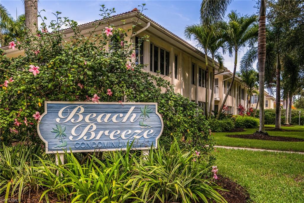 282 4th Street South, Unit 204 Naples, FL 34102 - Photo 13 of 16 a sign broad in front of the red brick house