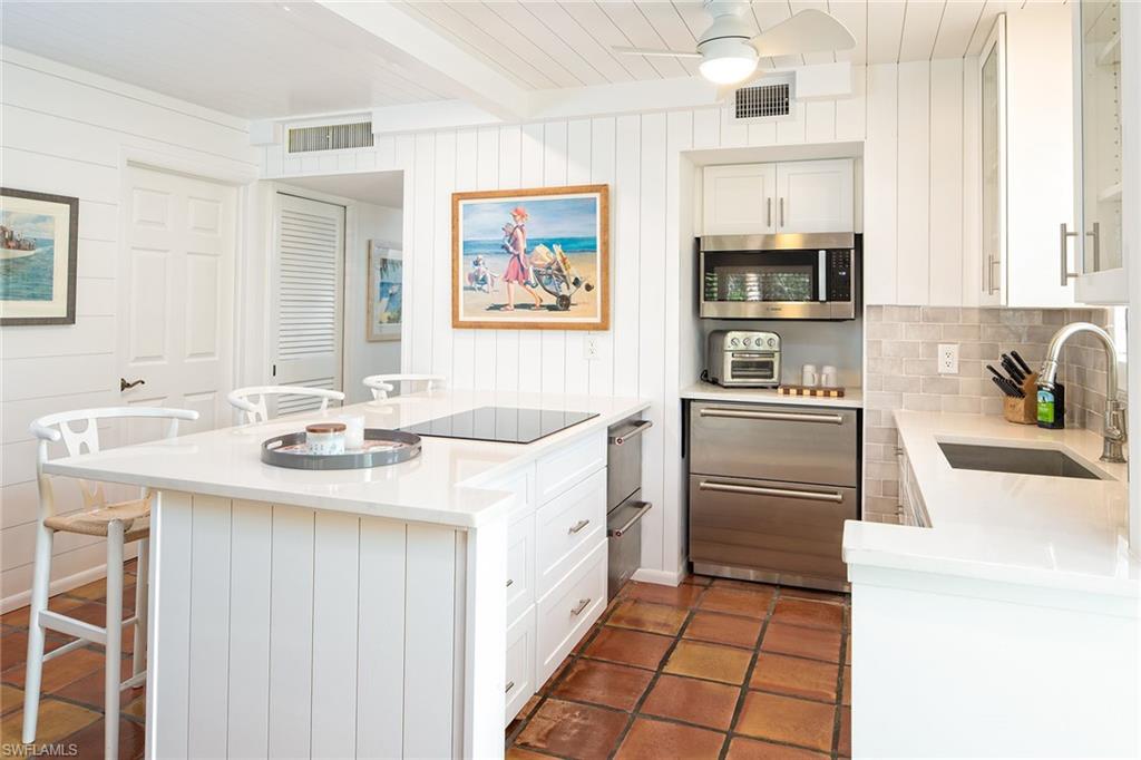 282 4th Street South, Unit 204 Naples, FL 34102 - Photo 3 of 16 a kitchen with a sink stove and refrigerator