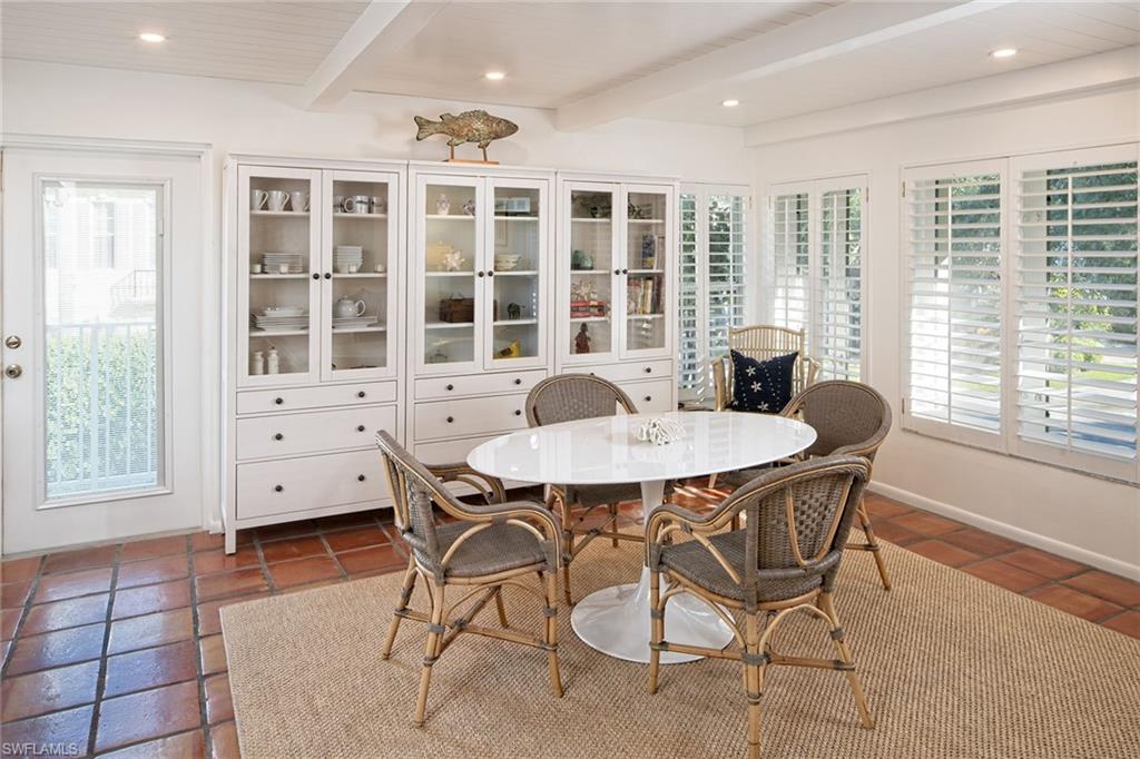 282 4th Street South, Unit 204 Naples, FL 34102 - Photo 4 of 16 a view of a dining room with furniture window and outside view