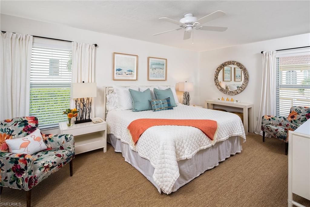 282 4th Street South, Unit 204 Naples, FL 34102 - Photo 5 of 16 a bed room with a bed and a chandelier