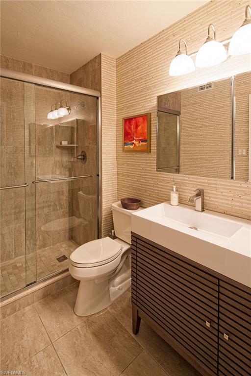 282 4th Street South, Unit 204 Naples, FL 34102 - Photo 6 of 16 a bathroom with a sink toilet and shower