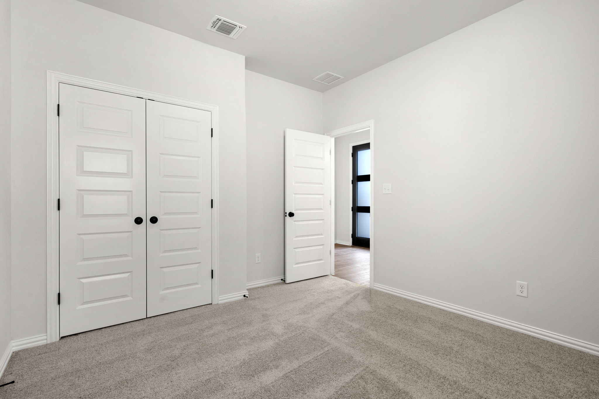 341 Fawn Riv Run Kyle, TX 78640 - Photo 20 of 29 Unfurnished bedroom with baseboards, visible vents, a closet, and carpet flooring