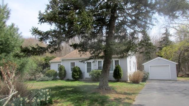 179 N Road Groton, CT 06340 - Photo 1 of 1 a front view of a house with a garden and trees