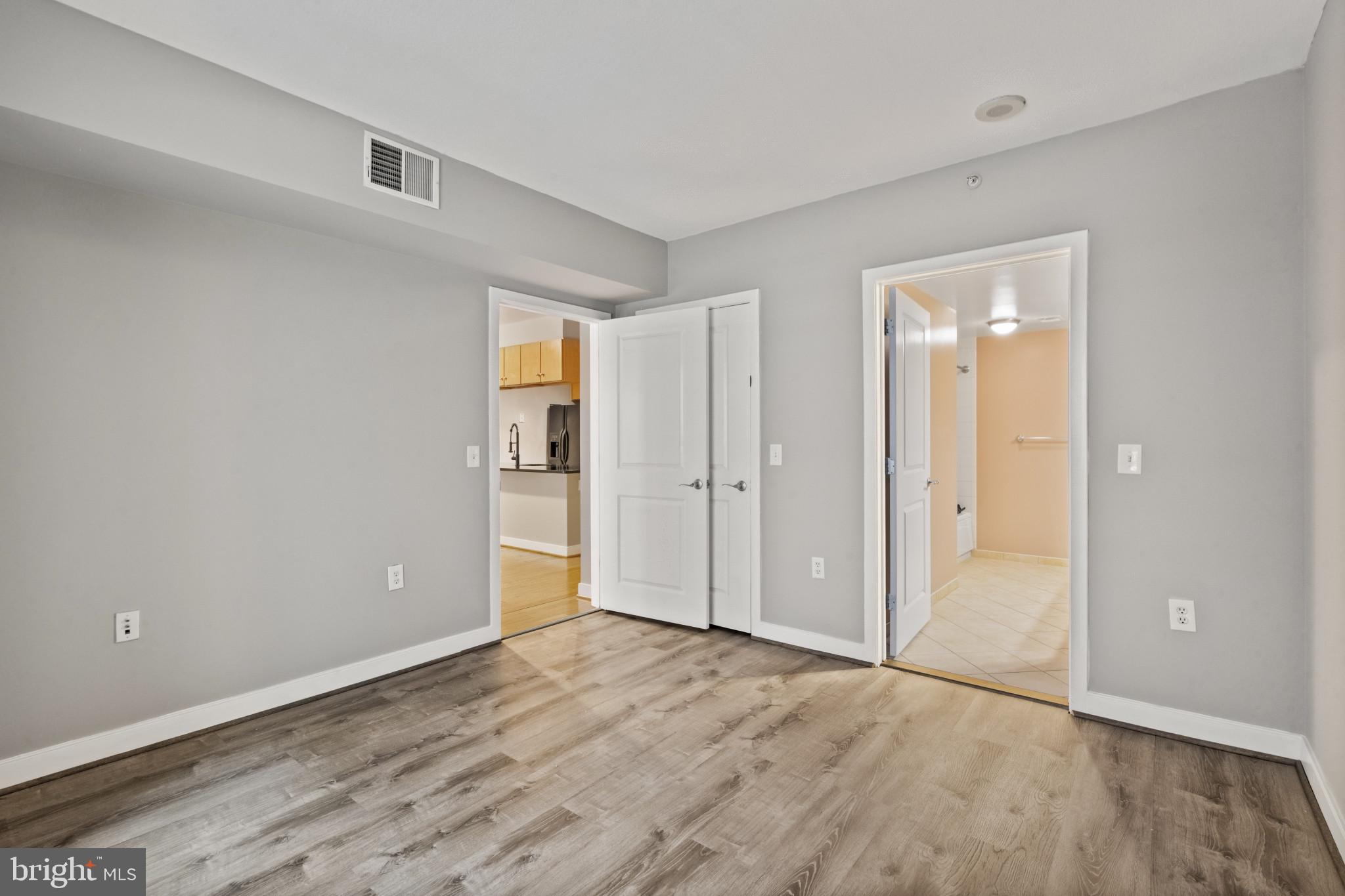 1117 10th Street Northwest, Unit 202 Washington, DC 20001 - Photo 13 of 29 a view of an empty room with wooden floor and closet